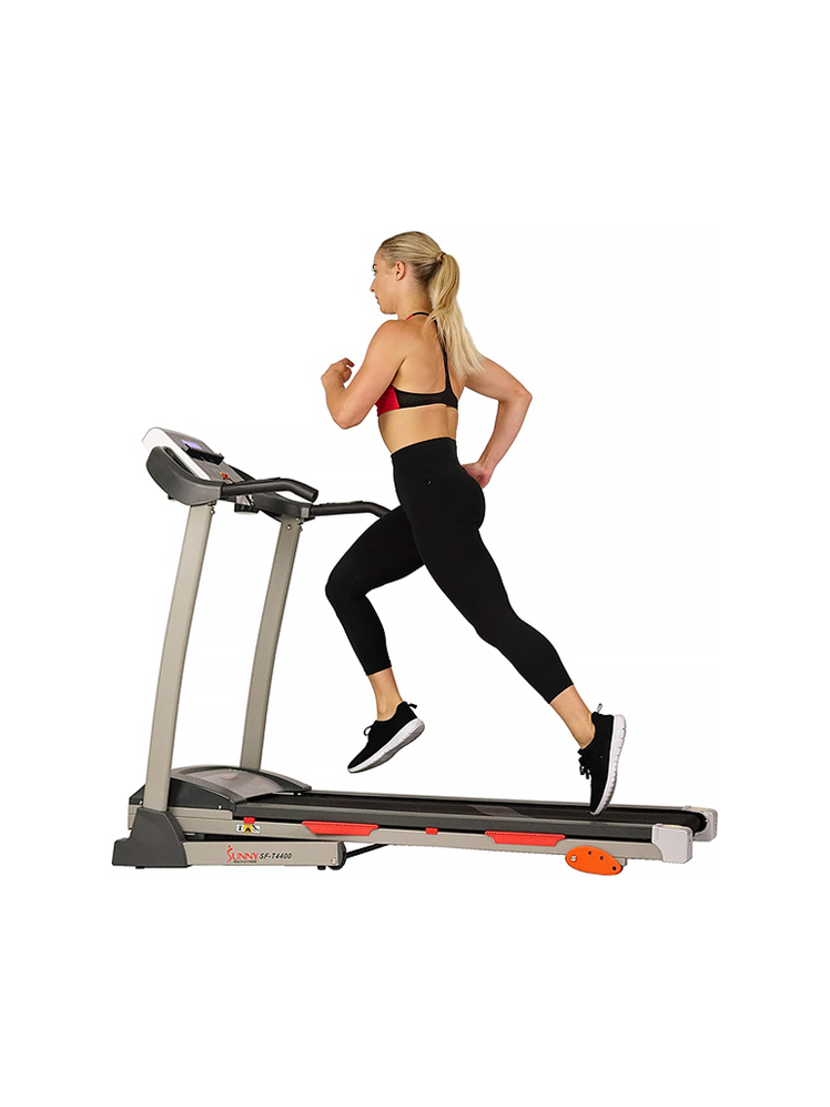 SFT4400 Treadmill in silver black and red with model on white background